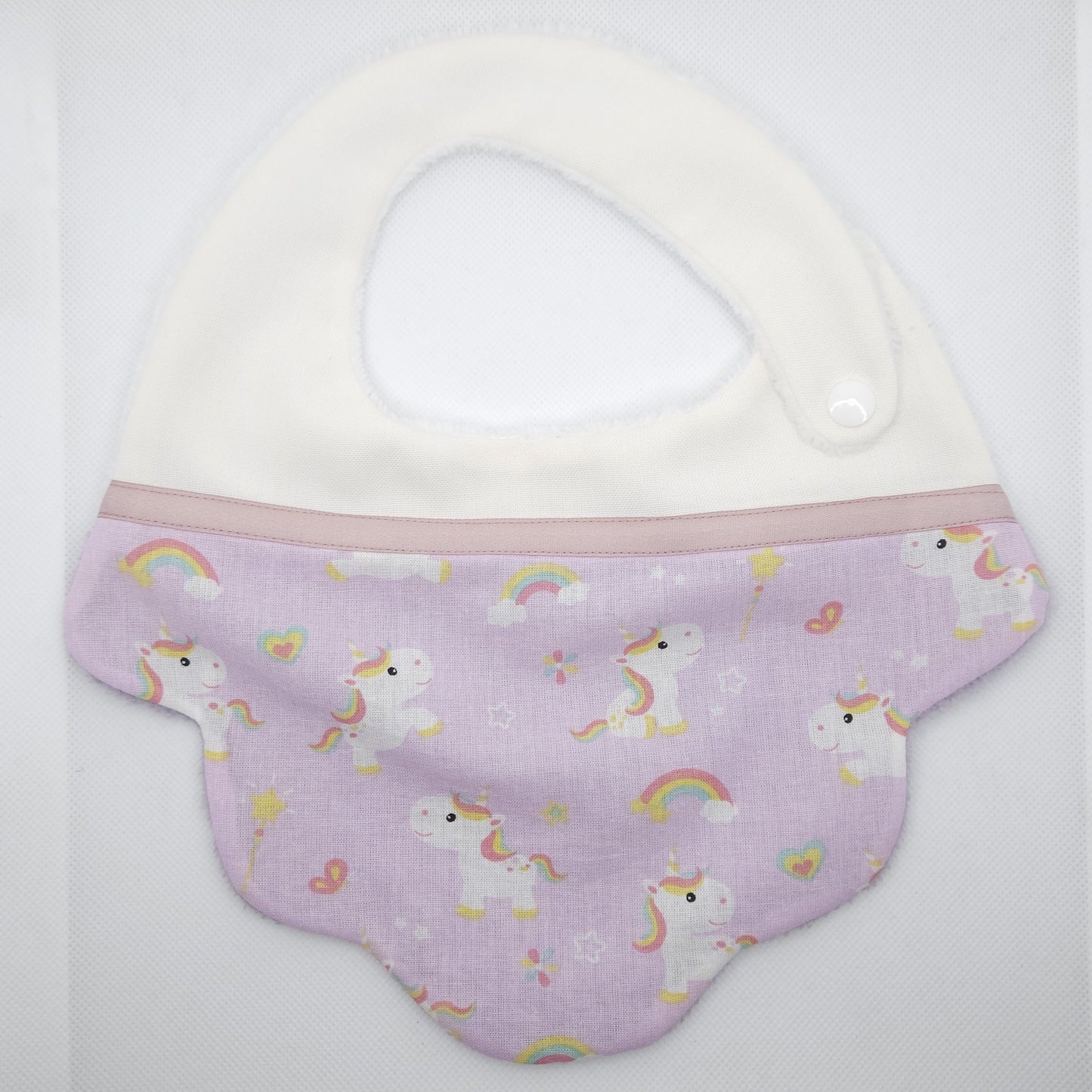 Baby bib with unicorn pattern on a white background