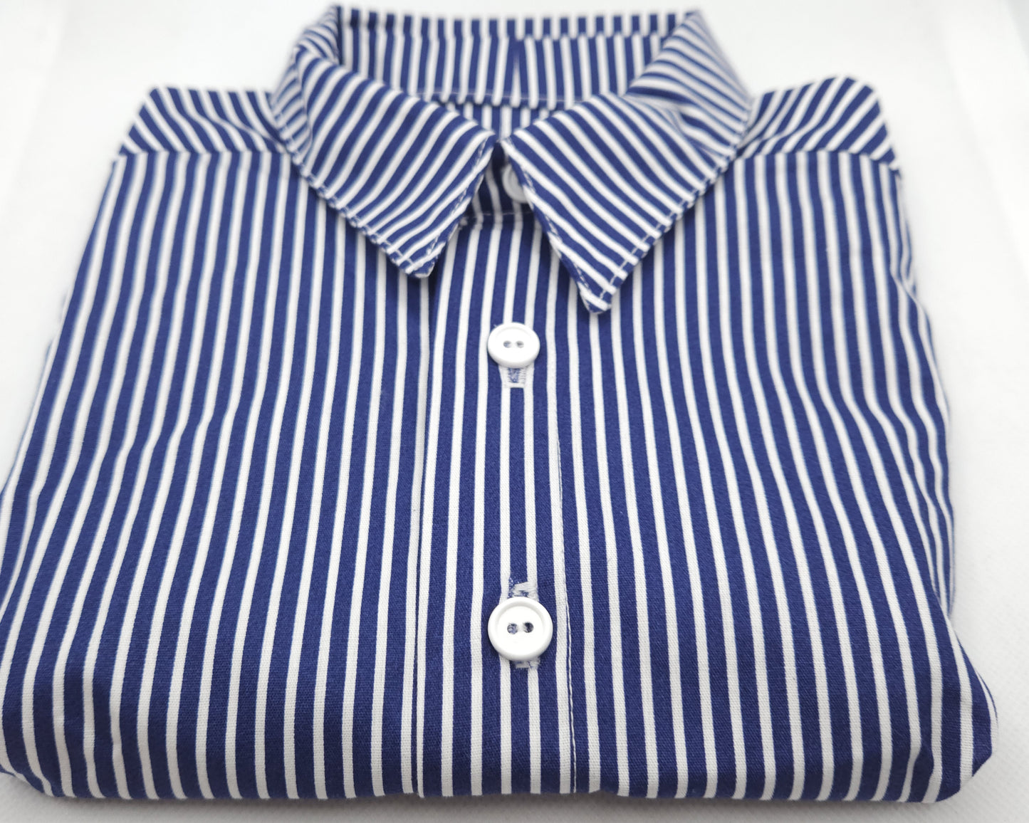 Folded blue and white striped shirt on a white background