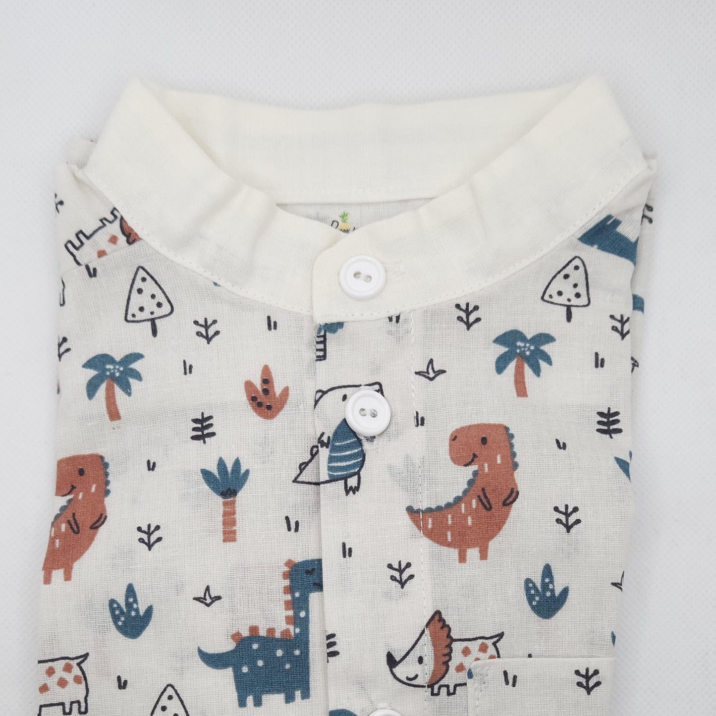 kid shirt with dinosaur and nature pattern on a white background
