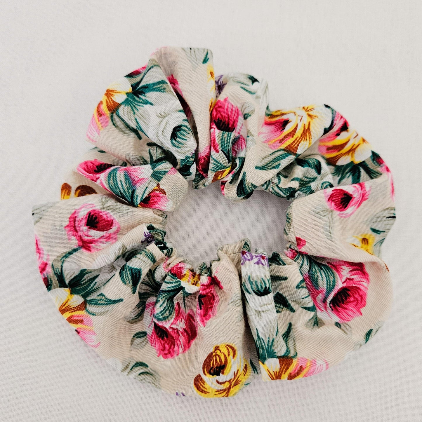 A floral scrunchie with a multicolored flower pattern