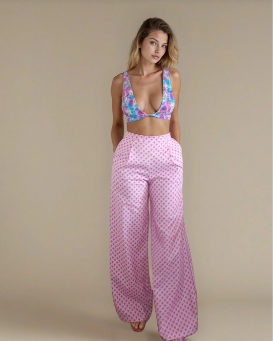 Woman wearing a colorful top and pink geometrical pants 