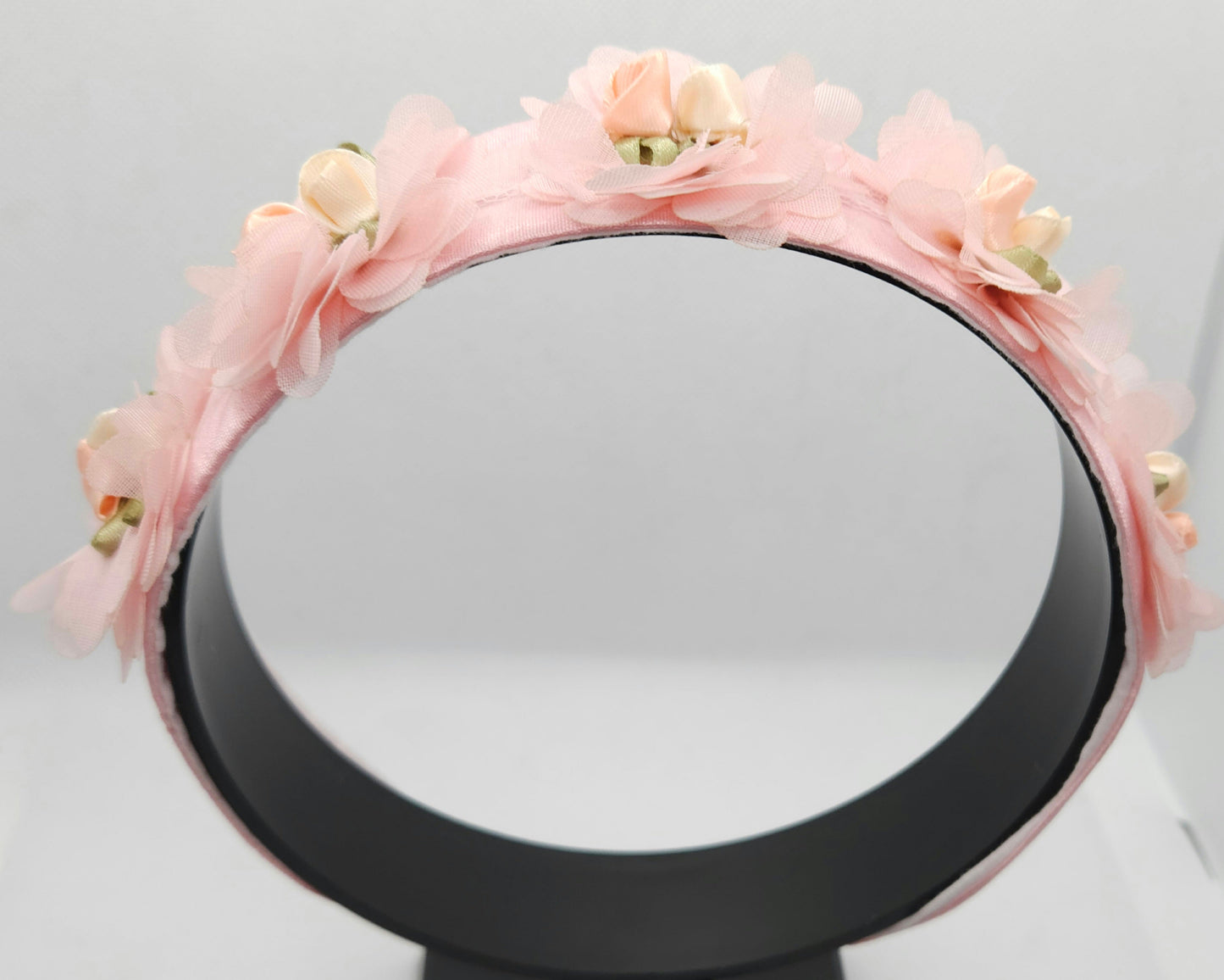 Floral headband with pink flowers on a gray background