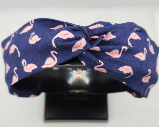 Navy blue headband with pink flamingo pattern on a white background