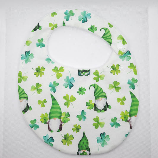 Baby bib with green elfs and shamrocks on a white background