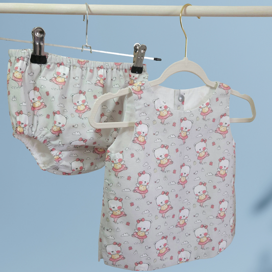 baby handmade top and nappy cover on blue background