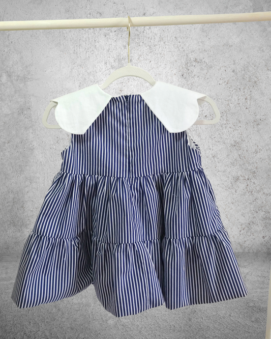 handmade Navy and white striped dress with a white collar on a hanger 