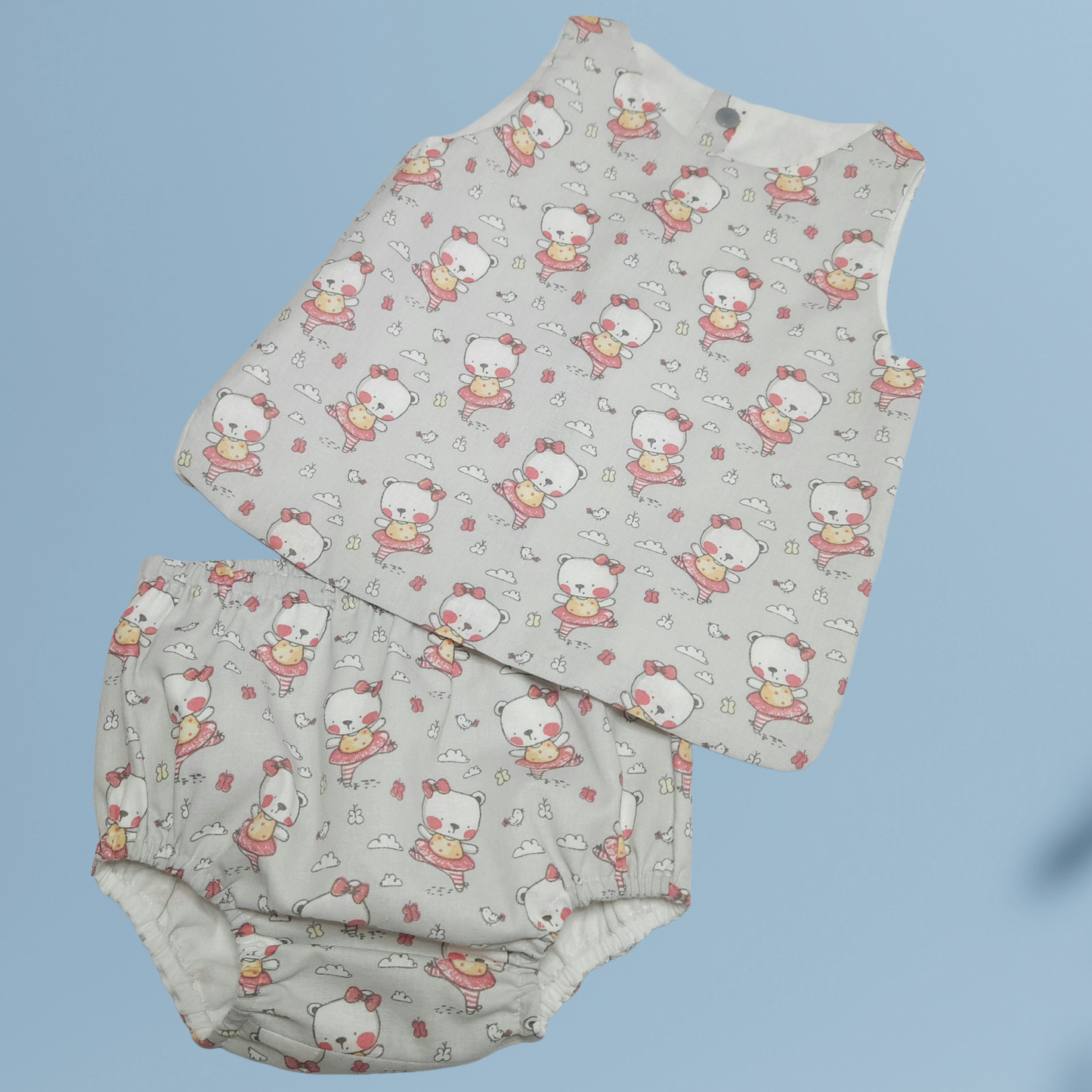 Baby top and bloomer with cartoon pattern on a light blue background