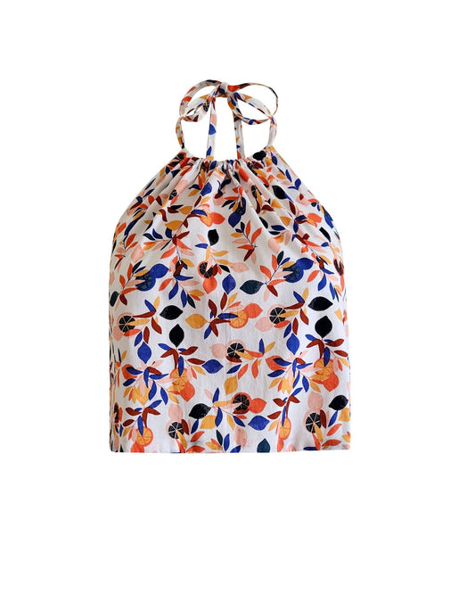 A floral print cotton top with a round neckline, short sleeves, and a tie at the waist, displayed against a white background.