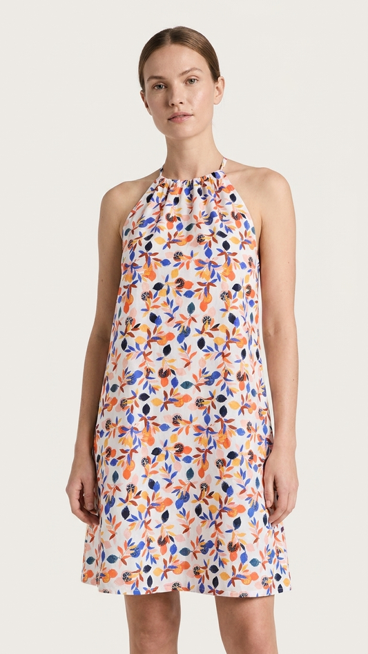 Woman wearing a floral dress on a plain background