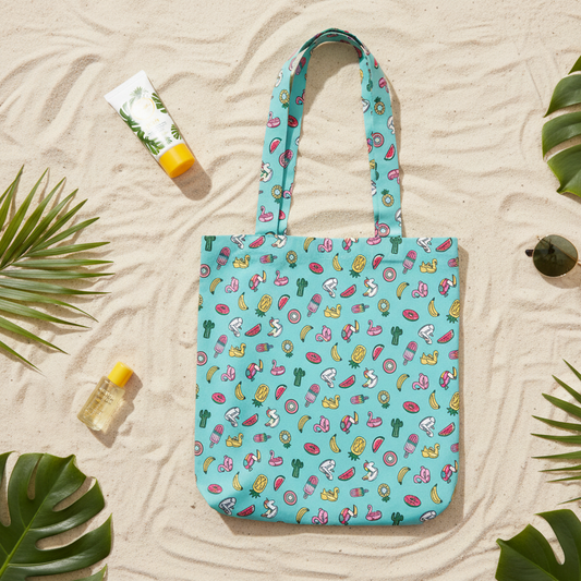 Colorful patterned tote bag on sandy surface with palm leaves 